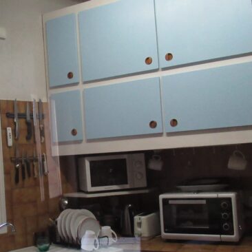 Kitchen with microwave and bench-top oven